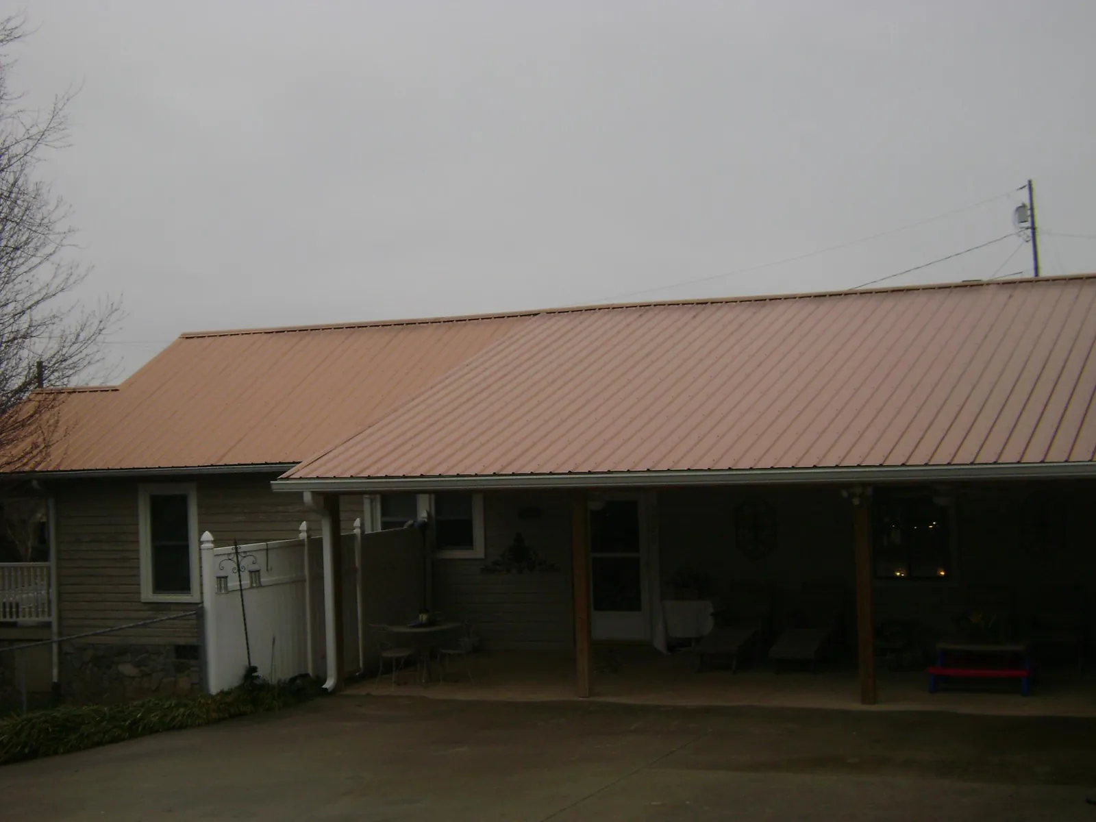 Copper toned metal roof over a wide covered patio in Richland